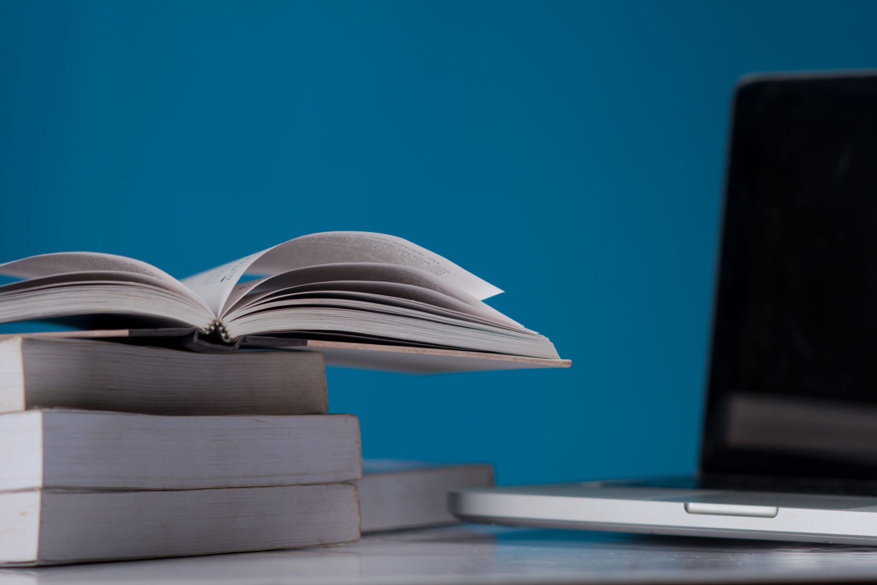 education concept, books and laptop at library